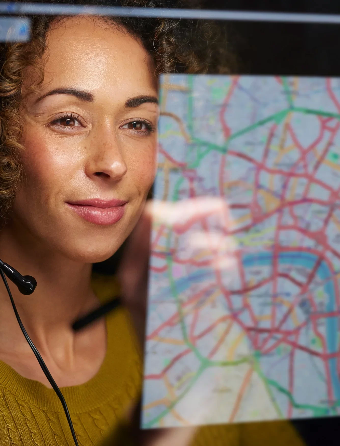 A woman looking at a map on a computer screen.